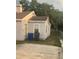 Backyard view of a single-story home with trees, a small yard, and a trash receptacle at 380 S Echo Dr, Lake Alfred, FL 33850