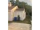 Backyard view of a single-story home with trees, a small yard, and a trash receptacle at 380 S Echo Dr, Lake Alfred, FL 33850