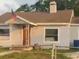 Charming single-story home featuring a welcoming entrance and a classic American flag at 380 S Echo Dr, Lake Alfred, FL 33850