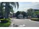Gated community entrance featuring lush landscaping, security booth, and controlled access at 4008 San Gallo Dr # 106, Kissimmee, FL 34741