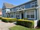Charming blue townhomes featuring white trim, well-manicured landscaping, and a welcoming curb appeal at 4008 San Gallo Dr # 106, Kissimmee, FL 34741