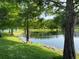 Scenic pond view features lush green grass, mature trees, and tranquil water at 4008 San Gallo Dr # 106, Kissimmee, FL 34741