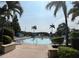 Community pool surrounded by lounge chairs and palm trees at 4008 San Gallo Dr # 106, Kissimmee, FL 34741