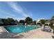 Community pool surrounded by landscaping, lounge chairs, and palm trees at 4008 San Gallo Dr # 106, Kissimmee, FL 34741