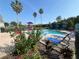 Community pool features clear blue water, lounge chairs, umbrellas and a playground at 4008 San Gallo Dr # 106, Kissimmee, FL 34741