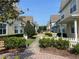 Beautiful street view featuring colorful townhomes, lush landscaping, and a neatly maintained walkway at 4008 San Gallo Dr # 106, Kissimmee, FL 34741