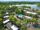 Aerial shot showcasing community pool, lush greenery, lake views, and nearby city skyline at 4017 Dijon Dr # 4017K, Orlando, FL 32808