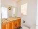 Bathroom featuring a wood vanity, tile backsplash, and framed mirror at 4017 Dijon Dr # 4017K, Orlando, FL 32808