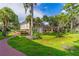 Multi-story building with well-maintained lawn, mature trees, and colorful landscaping at 4017 Dijon Dr # 4017K, Orlando, FL 32808