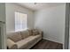 A cozy room with hardwood floors, a comfortable sofa, and plenty of natural light from the window at 4017 Dijon Dr # 4017K, Orlando, FL 32808