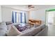 Cozy living room with a ceiling fan, hardwood flooring, and natural light from the sliding glass door at 4017 Dijon Dr # 4017K, Orlando, FL 32808
