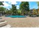 Large community pool surrounded by lounge chairs and landscaping at 4017 Dijon Dr # 4017K, Orlando, FL 32808