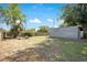 This backyard features a metal shed and a large grassy area perfect for outdoor activities and gardening at 416 E Seminole Ave, Lake Wales, FL 33853