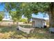 Enjoy a large backyard with lush greenery, hammocks, a shed, and comfortable seating areas at 416 E Seminole Ave, Lake Wales, FL 33853