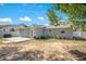 This expansive backyard includes a grey exterior, an exterior door, and well-maintained landscaping at 416 E Seminole Ave, Lake Wales, FL 33853