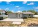 The backyard features a cement patio extending from the house, with a door leading into the home at 416 E Seminole Ave, Lake Wales, FL 33853