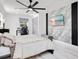 Bright bedroom features a decorative accent wall, sleek ceiling fan and a dedicated workspace at 416 E Seminole Ave, Lake Wales, FL 33853