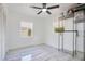 Bright bedroom with a modern ceiling fan, two windows with privacy shades and a large closet at 416 E Seminole Ave, Lake Wales, FL 33853