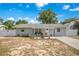 Charming single-story home featuring a well-manicured lawn, white fence, and inviting curb appeal at 416 E Seminole Ave, Lake Wales, FL 33853