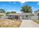Charming single-story home featuring a well-manicured lawn, white fence, and inviting curb appeal at 416 E Seminole Ave, Lake Wales, FL 33853