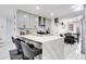 Modern kitchen featuring a large island with seating, light grey cabinetry, and stainless steel appliances at 416 E Seminole Ave, Lake Wales, FL 33853