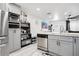 Modern kitchen featuring stainless steel appliances, sleek cabinetry, and stylish flooring at 416 E Seminole Ave, Lake Wales, FL 33853