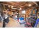 A well-lit shed with exposed wood beam ceiling used for storage with lawn equipment and other materials at 416 E Seminole Ave, Lake Wales, FL 33853