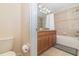 This bathroom showcases a classic vanity, tiled walls and floor, and a convenient shower-tub combination at 4875 Clock Tower Dr, Kissimmee, FL 34746