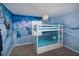 Charming bedroom featuring a unique 'Frozen' themed mural and a cozy bunk bed with decorative pillows at 4875 Clock Tower Dr, Kissimmee, FL 34746