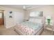 This bedroom offers a comfortable bed, complemented by bright floral bedding and stylish side tables with mirrored accents at 4875 Clock Tower Dr, Kissimmee, FL 34746