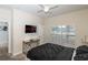 Inviting bedroom featuring a tv, modern ceiling fan, window, and cozy carpet flooring at 4875 Clock Tower Dr, Kissimmee, FL 34746
