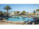Large community pool with palm trees and plenty of lounge chairs for relaxation and enjoyment at 4875 Clock Tower Dr, Kissimmee, FL 34746