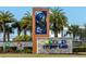 Beautiful sign for Storey Lake community with palm tree design and stone base at 4875 Clock Tower Dr, Kissimmee, FL 34746