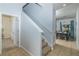 Bright entryway featuring tile floors, staircase, and a glimpse into the dining area at 4875 Clock Tower Dr, Kissimmee, FL 34746