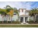 Charming townhome featuring well-maintained landscaping and a welcoming covered entrance at 4875 Clock Tower Dr, Kissimmee, FL 34746