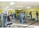 Community gym with several weight machines and exercise equipment in a well-lit space at 4875 Clock Tower Dr, Kissimmee, FL 34746