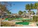 Fun mini golf course surrounded by tropical plants, palm trees, and lush landscaping at 4875 Clock Tower Dr, Kissimmee, FL 34746