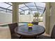 Private screened-in pool area with table and chairs, and a relaxing lounge chair at 4875 Clock Tower Dr, Kissimmee, FL 34746