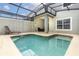 Private screened-in pool area with a lounge chair, table and chairs, and backyard view at 4875 Clock Tower Dr, Kissimmee, FL 34746