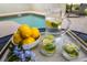A pitcher of lemon water with lemons and flowers in front of a beautiful community pool at 4875 Clock Tower Dr, Kissimmee, FL 34746