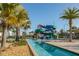 Resort-style community water slide and lazy river surrounded by tropical landscaping and palm trees at 4875 Clock Tower Dr, Kissimmee, FL 34746