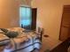 Well-lit bedroom with comfortable furnishings and a tiled floor at 4926 Reginald Rd, Orlando, FL 32829
