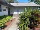 Welcoming entrance with well-maintained landscaping, inviting front door, and decorative welcome sign at 4926 Reginald Rd, Orlando, FL 32829