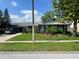 Charming single-story home featuring lush landscaping, manicured lawn, and a welcoming entrance at 4926 Reginald Rd, Orlando, FL 32829