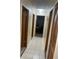 Bright hallway with tile flooring leading to rooms with wood trim doors, offering a clean and welcoming transition space at 4926 Reginald Rd, Orlando, FL 32829