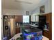 Well-lit kitchen with stainless steel appliances, wood cabinets, and an aquarium, blending modern convenience with unique accents at 4926 Reginald Rd, Orlando, FL 32829
