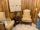 Cozy seating area featuring two upholstered chairs and wood paneling, creating a rustic and inviting atmosphere at 4926 Reginald Rd, Orlando, FL 32829