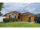 Charming single-story home featuring a well-maintained lawn, complementary landscaping, and an attached two-car garage at 513 Ronshelle Ave, Haines City, FL 33844