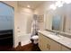 This bathroom has a shower over the tub, granite vanity, updated fixtures and vinyl floor at 5356 Diplomat Ct # 108, Kissimmee, FL 34746