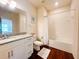 This modern bathroom features a granite-topped vanity, toilet, and bathtub with white tiled walls at 5356 Diplomat Ct # 108, Kissimmee, FL 34746